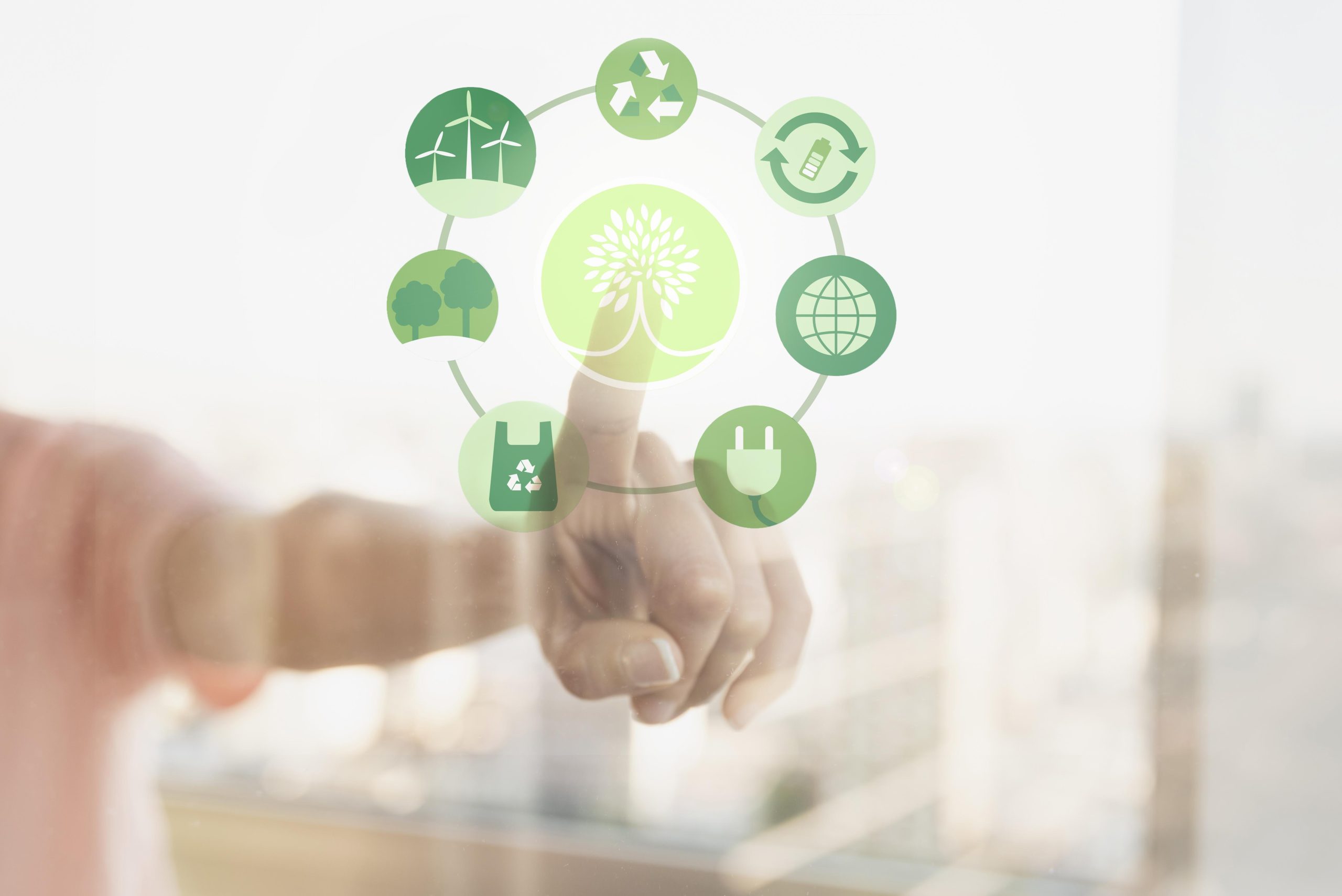 A person touching a transparent screen displaying eco-friendly icons, symbolising sustainability and the growing trend of green credit cards promoting environmental responsibility.